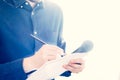 Male journalist at news conference, holding microphone and taking notes Royalty Free Stock Photo