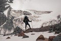 Journeyman with full climbing equipment stands on mountain