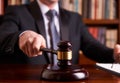 Male judge in a courtroom striking the gavel Royalty Free Stock Photo