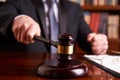 Male judge in a courtroom striking the gavel Royalty Free Stock Photo