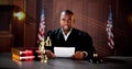 Male Judge Reading Documents While Sitting At Desk Royalty Free Stock Photo