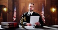 Male Judge Reading Documents While Sitting At Desk