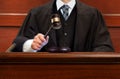 Male judge striking the gavel after giving verdict in the courtroom Royalty Free Stock Photo