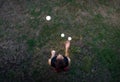 Male juggler juggling with balls from above