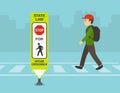 Male kid crossing the street on crosswalk. Close-up of a `Stop for pedestrians within crosswalk. Royalty Free Stock Photo