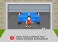 Male kid plays with ball while door is closing.Garage door safety tips and rules.