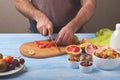 Male on a kitchen table preparing fruit salad Royalty Free Stock Photo