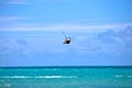 Male Kitesurfer grabing his board