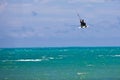 Male Kitesurfer grabing his board