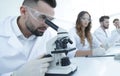 Male laboratory technician looking at samples in the microscope Royalty Free Stock Photo