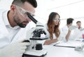 Male laboratory technician looking at samples in the microscope Royalty Free Stock Photo
