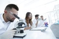 Male laboratory technician looking at samples in the microscope Royalty Free Stock Photo