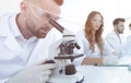 Male laboratory technician looking at samples in the microscope Royalty Free Stock Photo