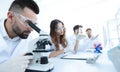 Male laboratory technician looking at samples in the microscope Royalty Free Stock Photo