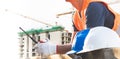 Male laborers are working in the building construction site.