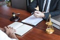 Male lawyer discussing negotiation legal case with client meeting with document contact in courtroom, law and justice concept Royalty Free Stock Photo