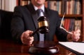 Male lawyer or judge hand`s striking the gavel Royalty Free Stock Photo