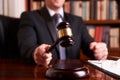 Male lawyer or judge hand`s striking the gavel Royalty Free Stock Photo