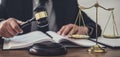 Male lawyer or judge working with contract papers, Law books and wooden gavel on table in courtroom, Justice lawyers at law firm, Royalty Free Stock Photo