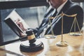 Male lawyer or judge working with contract papers, Law books and wooden gavel on table in courtroom, Justice lawyers at law firm, Royalty Free Stock Photo