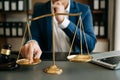 Male lawyer in the office with brass scale on wooden table. justice and law concept Royalty Free Stock Photo