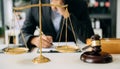 Male lawyer in the office with brass scale on wooden table. justice and law concept Royalty Free Stock Photo