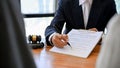 Male lawyer showing the contract paper to his clients during the meeting. cropped image Royalty Free Stock Photo