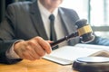 Male lawyer working with contract papers and reading law book in a courtroom, justice and law concept while presiding over trial Royalty Free Stock Photo