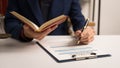 Male lawyer working with law book, A legal binding, Unilateral contract, Multilateral, Non-reciprocal contract, Default, Royalty Free Stock Photo