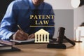 Male lawyer working at table in office, focus on gavel. Patent Law Royalty Free Stock Photo