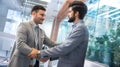 Male leader boss shaking hand of new staff member welcoming young male businessperson on job in corporate department. Royalty Free Stock Photo