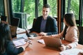 Male leader explaining business strategy with diverse business people in conference room. Royalty Free Stock Photo