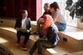 Male lector holding laptop and communicating with his students