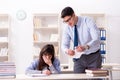 The male lecturer giving lecture to female student Royalty Free Stock Photo