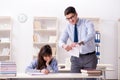 The male lecturer giving lecture to female student Royalty Free Stock Photo