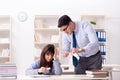 The male lecturer giving lecture to female student Royalty Free Stock Photo