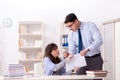 The male lecturer giving lecture to female student Royalty Free Stock Photo