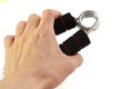 A male left hand holding a black hand muscle gripper trainer Royalty Free Stock Photo
