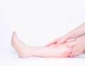 Male leg on a white background, a man holding his leg has a broken bone, medical, copy space, gastrocnemius muscle Royalty Free Stock Photo