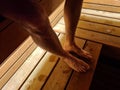 Male legs and feet sweat while relaxing in sauna Royalty Free Stock Photo