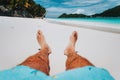 Male legs feet on tropical beach. Enjoying relaxing vacation holiday pov concept Royalty Free Stock Photo