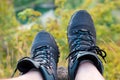 Male legs in hiking boots resting on hillside. Relaxing time during a trekking in a mountains