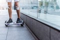 Male legs riding on hoverboard near shop-window Royalty Free Stock Photo