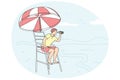 Male lifeguard on tower on beach