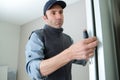 Male lockpicker fixing door handle at home