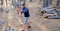 Male logger chopping wood with an axe in the forest 4k