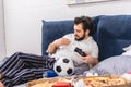 male loner playing video game in bedroom and removing spot Royalty Free Stock Photo