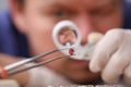 Male looks through magnifying glass brink diamond