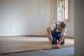 Male lying parquet floor board/laminate flooring Royalty Free Stock Photo
