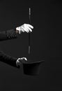 Male magician showing tricks on dark background Royalty Free Stock Photo